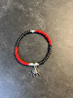 "Spider-Man inspired stretch beaded bracelet with stainless steel spider charm.  All bracelets are made a standard 7 inches, if you need a different size please let me know in the notes or feel free to message me. X-S 6\" SM-6.5\" MD-7\" LG-7.5\" XL-8\"" Black Novelty Stretch Bracelet As A Gift, Black Novelty Stretch Bracelet For Gift, Adjustable Red Beaded Bracelets For Halloween, Spider Man Bracelet, Spider Man Miles, Bracelets Ideas, Beads Bracelet Design, Bracelet Design, Bracelet Ideas