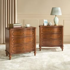 two wooden dressers sitting next to each other on top of a carpeted floor