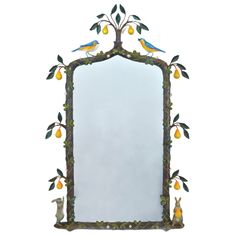 a mirror that has birds on it and fruit around the edges, as well as an animal figurine