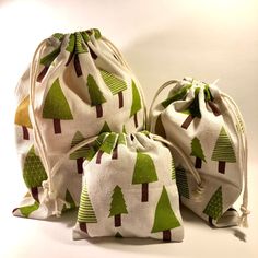 three bags with trees on them sitting next to each other