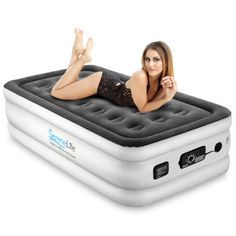 a woman laying on top of an inflatable mattress