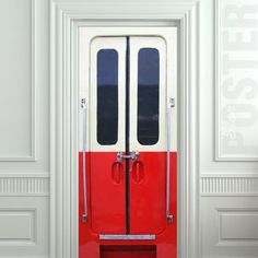 a red and white door with two black doors on each side in an empty room