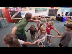 a group of young children standing around each other in a circle with their hands together