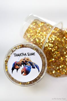 a jar filled with gold glitter next to a small container full of it's contents