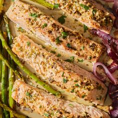 grilled salmon and asparagus on a white platter with red onion wedges