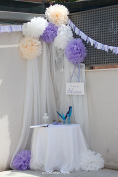 a white table topped with purple and white flowers