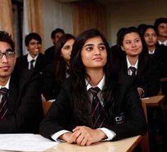 a group of young people sitting at desks