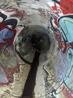 the inside of a pipe with graffiti all over it