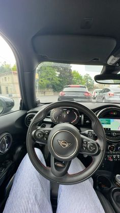 the interior of a small car with dashboard and steering wheel view from driver's seat