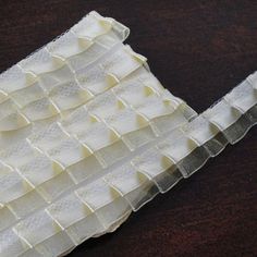 a piece of cloth with white ruffles on it