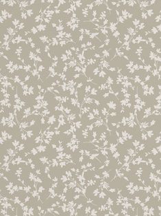 a gray and white floral wallpaper with small flowers on the side, as well as leaves