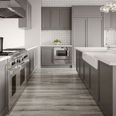 a large kitchen with stainless steel appliances and marble counter tops