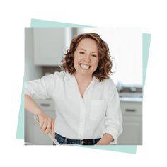 a woman is smiling while cooking in the kitchen