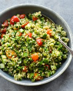 a bowl filled with lots of veggies on top of a gray countertop