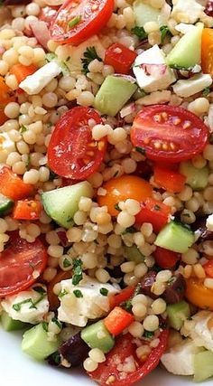 a salad with tomatoes, cucumbers and other vegetables