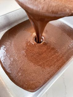 chocolate being poured into a baking pan