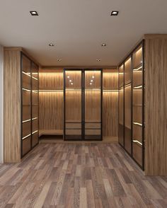 an empty walk - in closet with wooden shelves and lighted lights on the walls, along with hardwood flooring