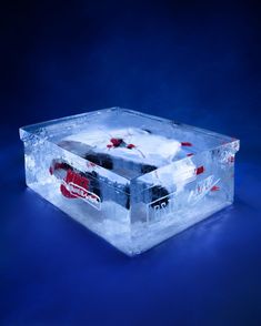 an ice box with coca cola in it on a blue background and some snow around the edges