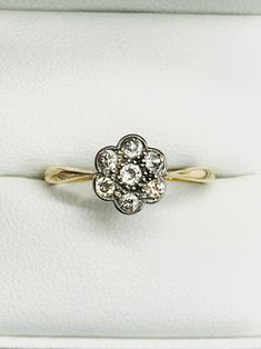 a diamond ring sitting on top of a white box