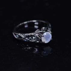 This piece has been inspired by natural forms of majestic glaciers, intricate elements of northern folklore and frozen creeks sparkling in the sun. All these elements woven together hold the main symbol of the north: stone clear as ice and bright like snow. Model 33-6 Moonstone Center Stone - Round 6 mm, Genuine, VVS1-Clarity, Ex-Cut, Ex-Polish, VG-Symmetry) and 8- Alexandrite Accents 0.1 CTW with 14K Black Gold or Black Platinum. Black Rhodium Plated. Please remember that you can customize this Unique Wedding Band Sets, Gothic Engagement Ring, Celtic Engagement Rings, Nature Inspired Engagement Ring, Black Stone Ring, Black Engagement Ring, Moonstone Engagement Ring, Gothic Rings, Unusual Jewelry