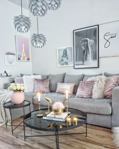 a living room filled with lots of furniture next to a coffee table and chandelier