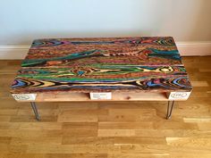 a wooden bench sitting on top of a hard wood floor