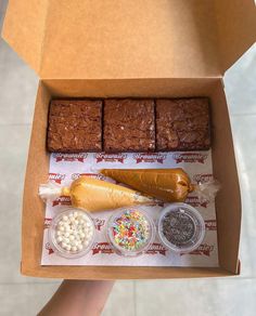 a box filled with brownies, marshmallows and sprinkles