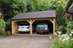 two cars are parked in the garage next to each other and one car is on the driveway