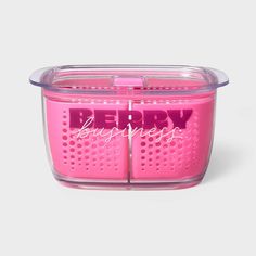 a pink plastic container with the words berry on it's side and an open lid