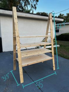 a wooden bench sitting on top of a sidewalk next to a building with measurements in front of it