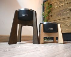 two wooden stools sitting next to each other on top of a hard wood floor