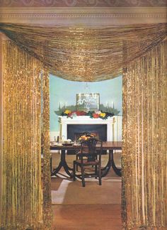 an elegant dining room with gold drapes on the ceiling and fireplace in the background