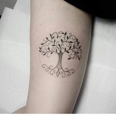 a small tree tattoo on the arm