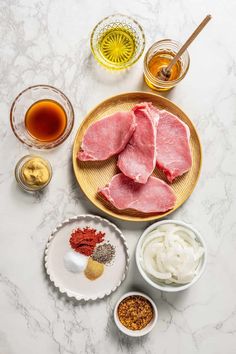 raw meat on a plate with spices and condiments