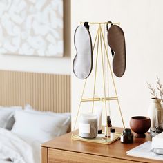 a bedroom with a bed, dresser and accessories on the table in front of it