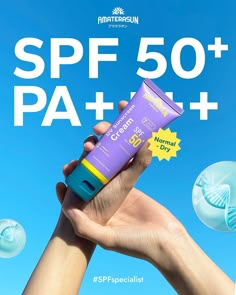 a hand holding a tube of sunscreen against a blue sky with the words spf 50 + plus