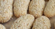 sesame seed cookies are lined up on a table