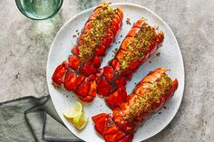 cooked lobsters on a white plate with seasoning and pepper sprinkles