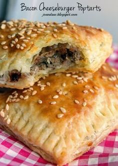 two pastries sitting on top of a red and white checkered table cloth