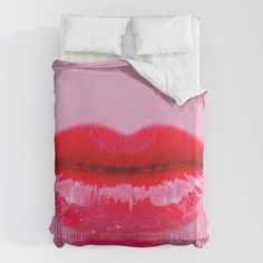 a bed with pink and red lips on it