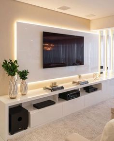 a living room with a large flat screen tv mounted on the wall