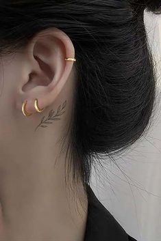 a close up of a person with ear piercings