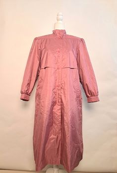 "Vintage Chiango by fleet street 80's pink trench coat.  Amazing coat that will make you want to play in the weather.  Six button snaps for closure.  Button snaps on cuffs, built in shoulder pads, as well as additional lining for extra warmth that can be removed.  Comes with matching waist belt.   Outershell is 100% polyester face, 100% rubber back, lining is nylon, filling is 100% polyester.  Marked size 14, in great vintage condition!   *Please double check measurements to make sure it's a goo Oversized Pink Outerwear With Button Closure, Oversized Pink Outerwear For Daywear, Pink Oversized Outerwear For Daywear, Pink Outerwear For Daywear In Fall, Pink Raincoat For Fall Rainy Weather, Pink Fall Raincoat For Rainy Weather, Spring Long-sleeved Raincoat With Button Closure, Spring Long Sleeve Raincoat With Button Closure, Solid Color Raincoat With Button Closure For Spring