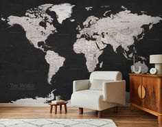 a living room with a large map on the wall and a chair in front of it