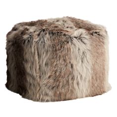 a furry stool is shown on a white background and it looks like an ottoman or poufce