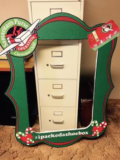 a green and white file cabinet with santa's helpers sticker on it