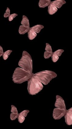 a group of pink butterflies flying in the air