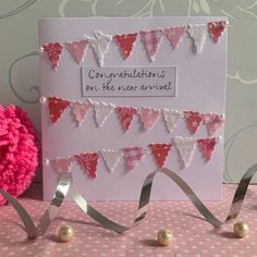 congratulations card with pink and white buntings on the side, next to flowers