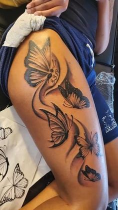 a woman's thigh with butterflies on it