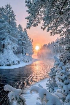 the sun is setting over a river surrounded by snow covered trees